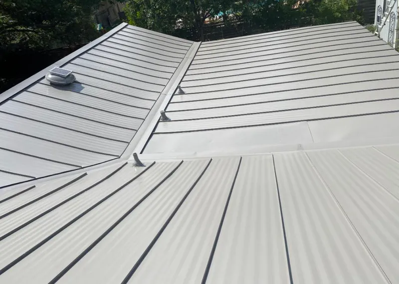 Solar attic fan installed on a metal roof for Roof Ventilation in Homer